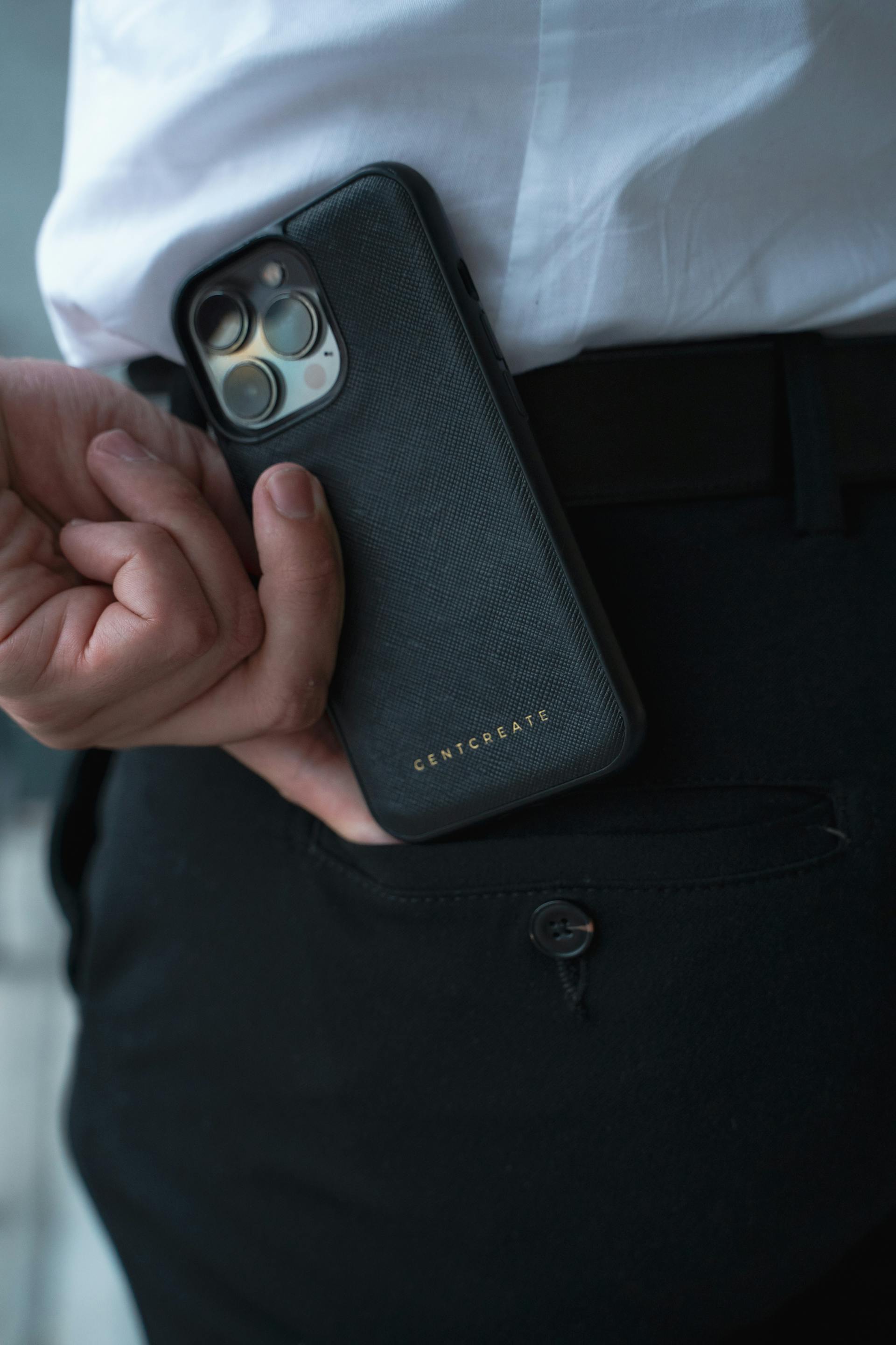 A man taking his phone out of his pocket | Source: Pexels