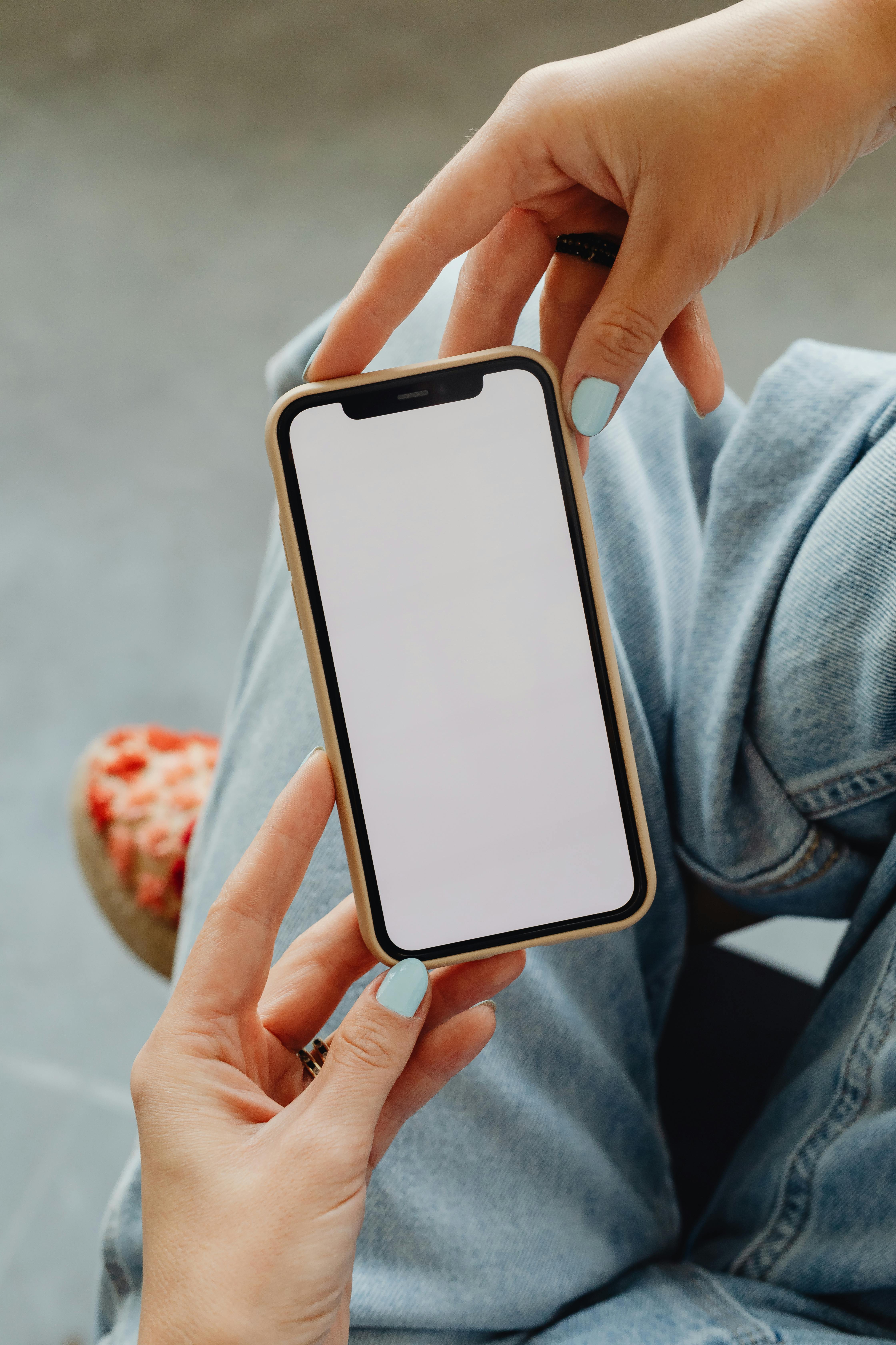 Woman holds smartphone in her hands | Source: Pexels