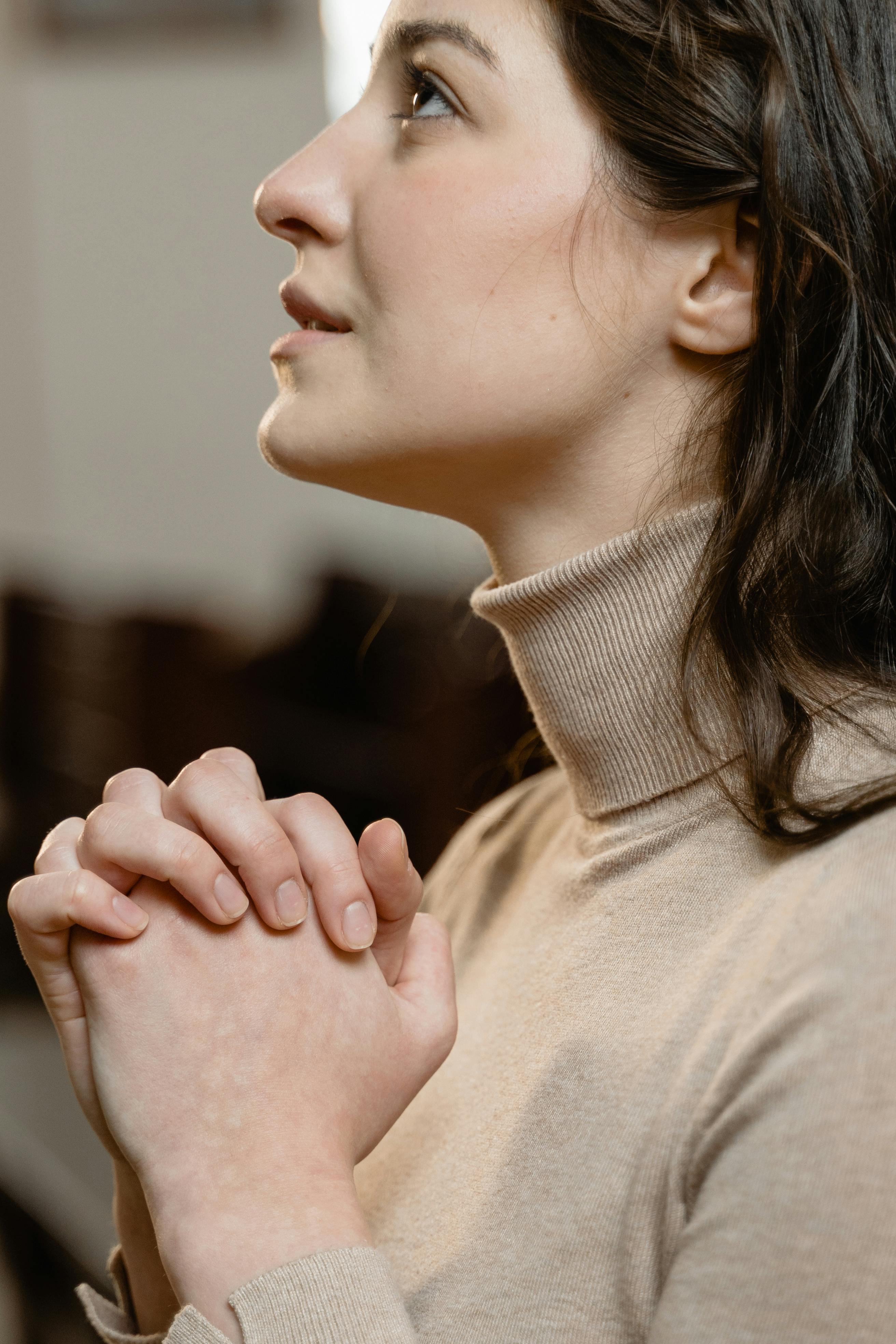 A hopeful woman praying | Source: Pexels