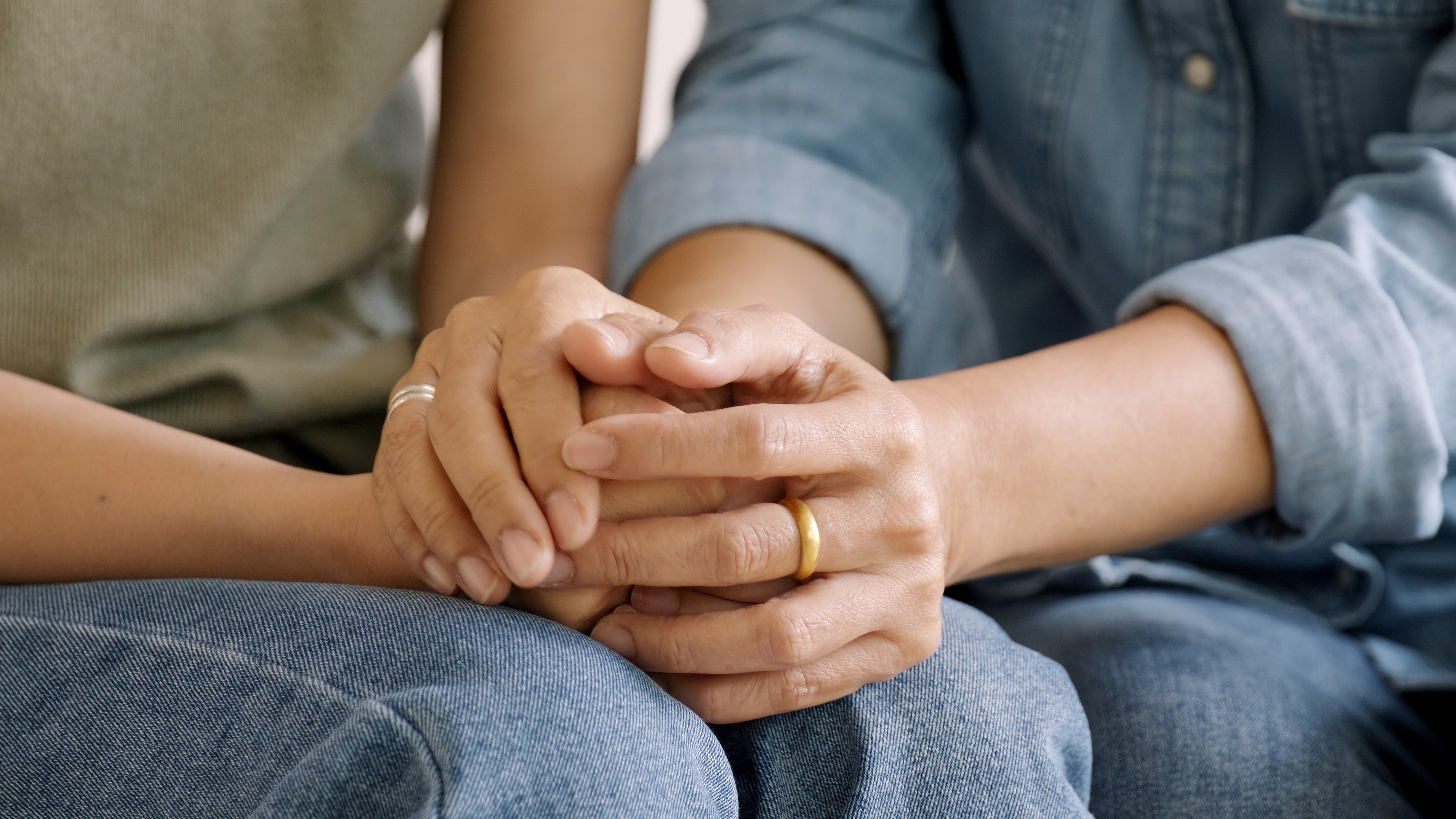 Two people holding hands | Source: Shutterstock