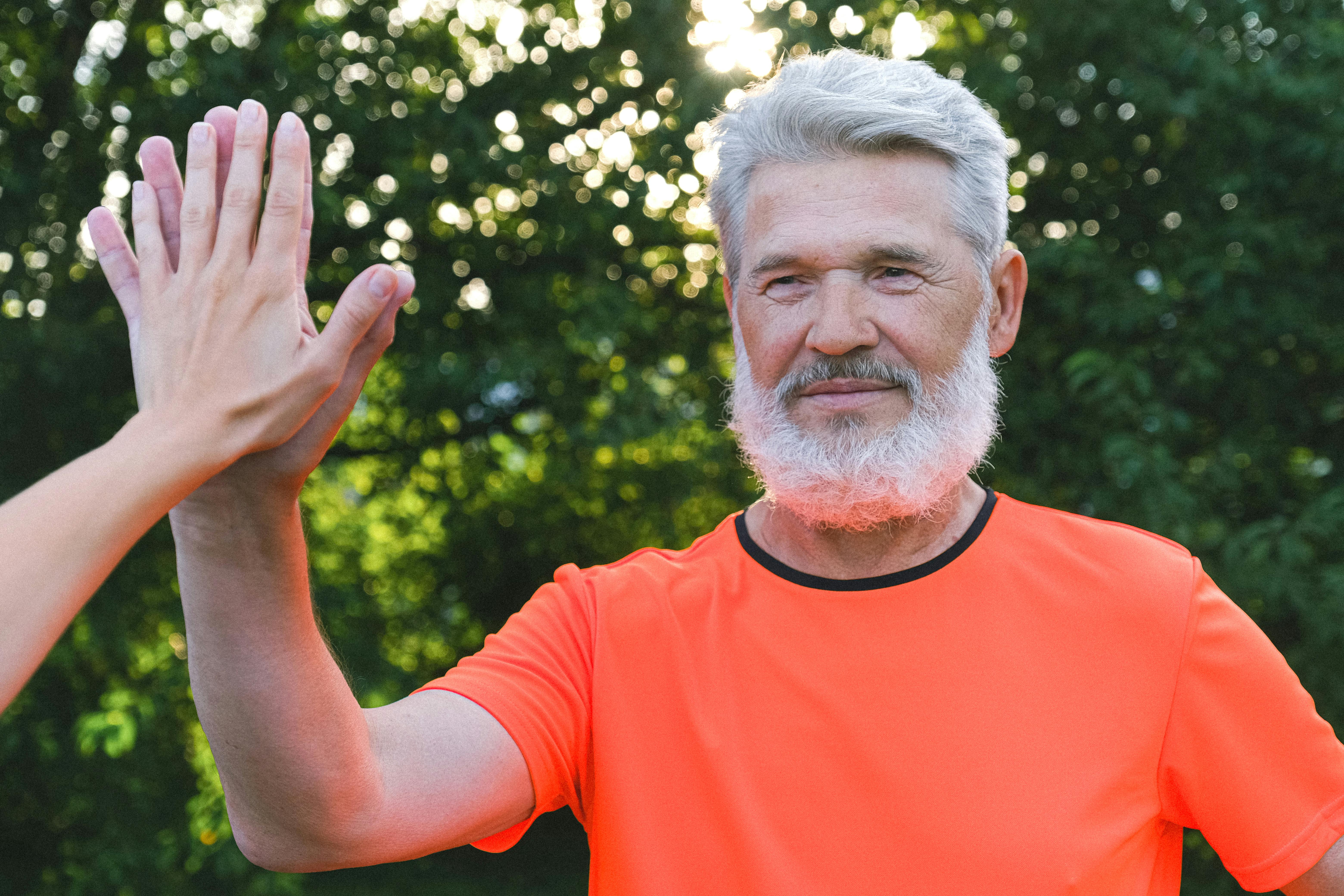 Senior man giving hi five to a friend | Source: Pexels