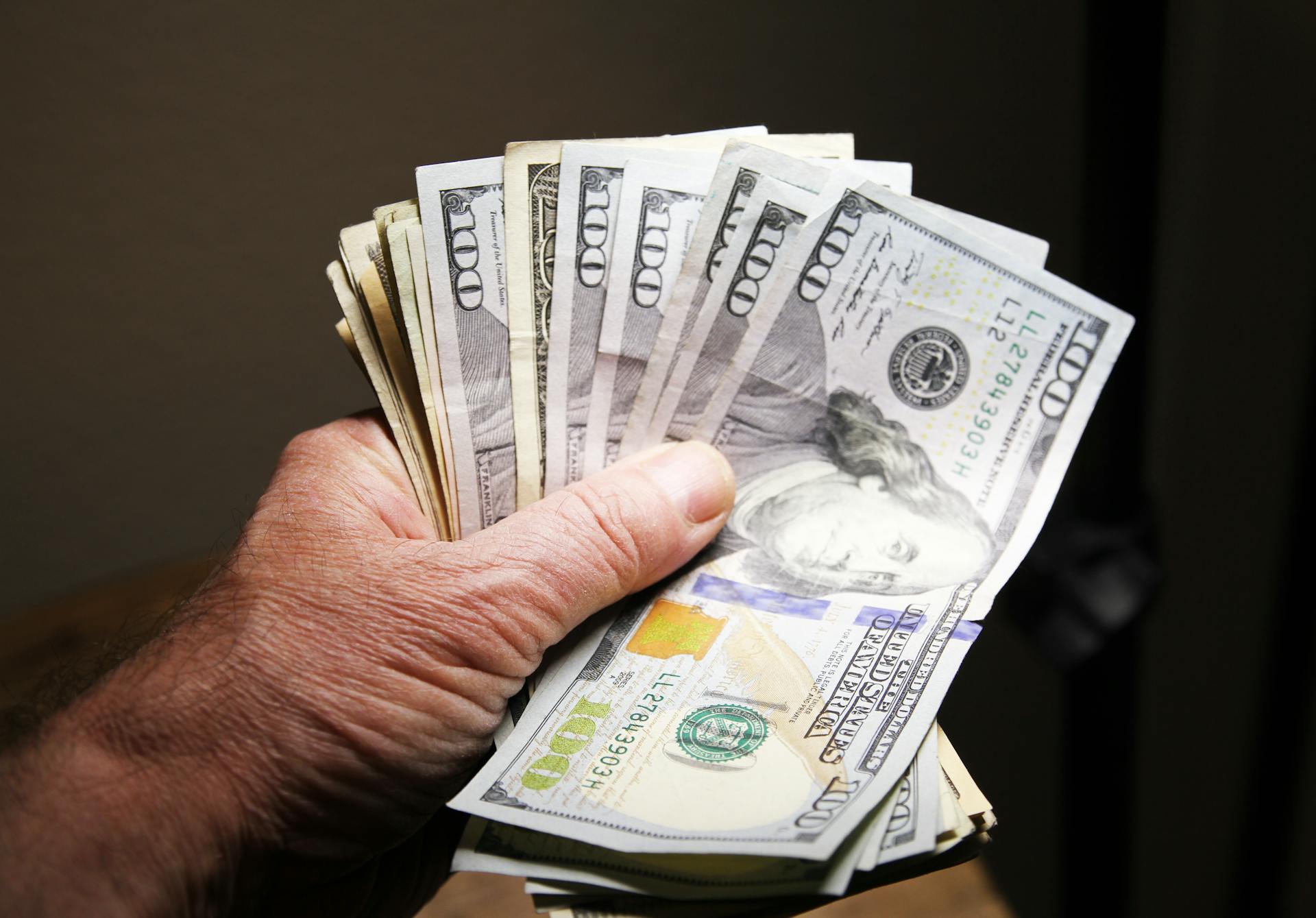 Close-up of a man holding money | Source: Pexels