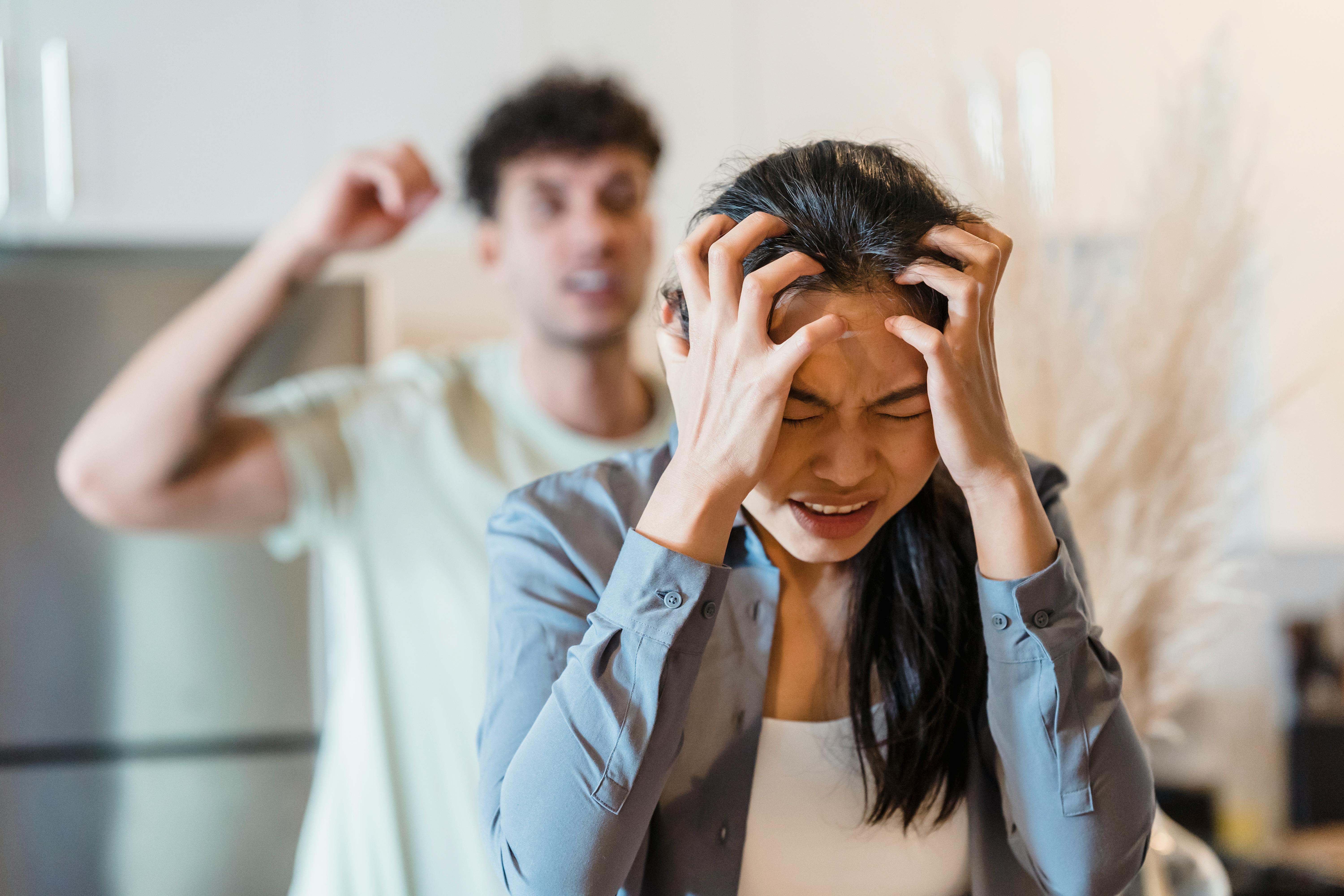 A woman clutching her head | Source: Pexels