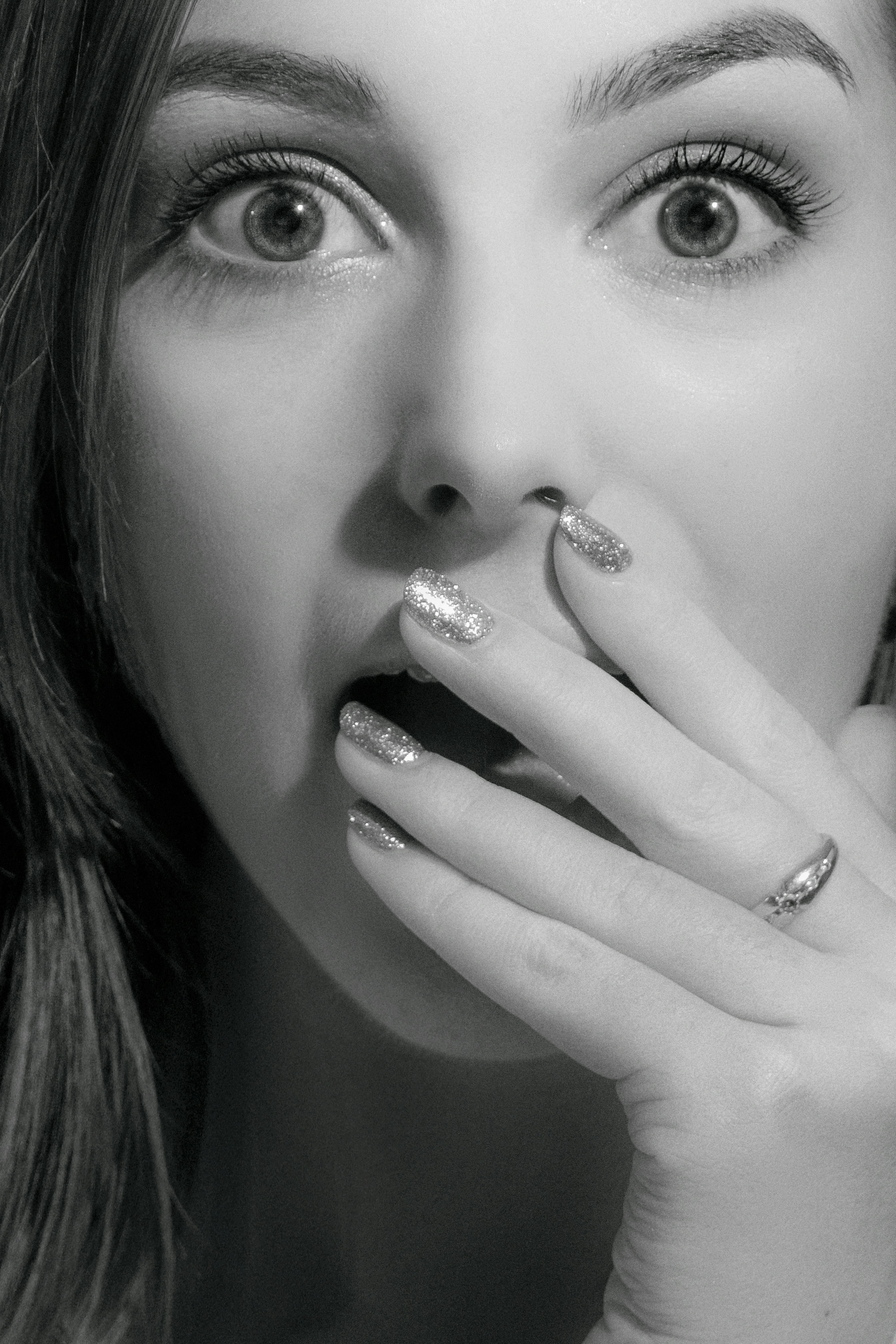 Woman covers her mouth with a hand | Source: Pexels