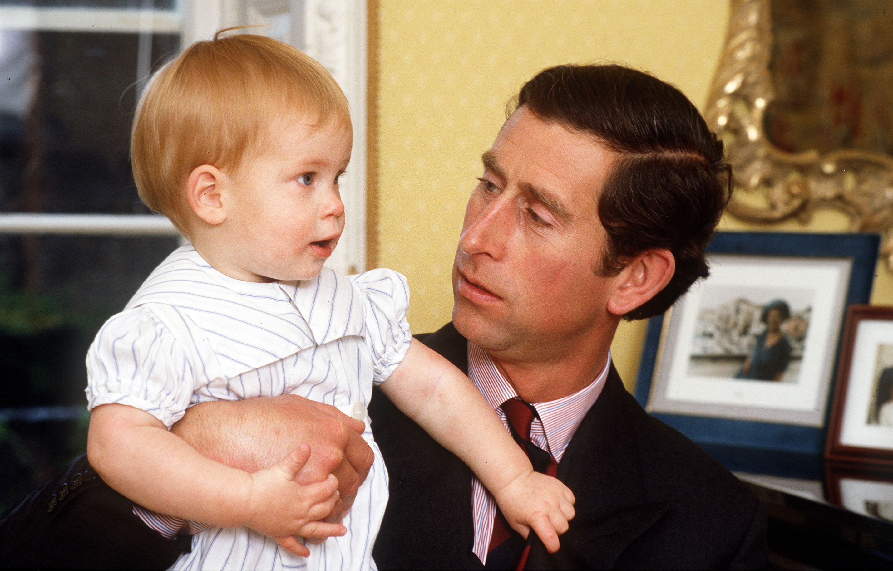 Prince Harry and King Charles III posing for a picture at home in Kensington Palace on October 4, 1985 | Source: Getty Images