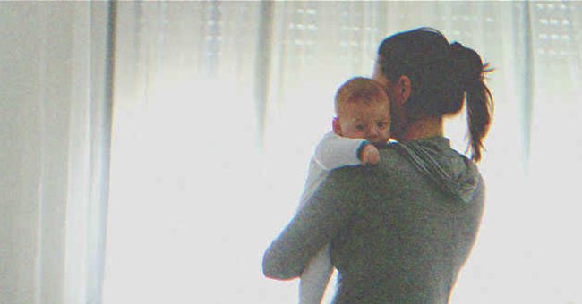 A woman holding a baby | Source: Shutterstock