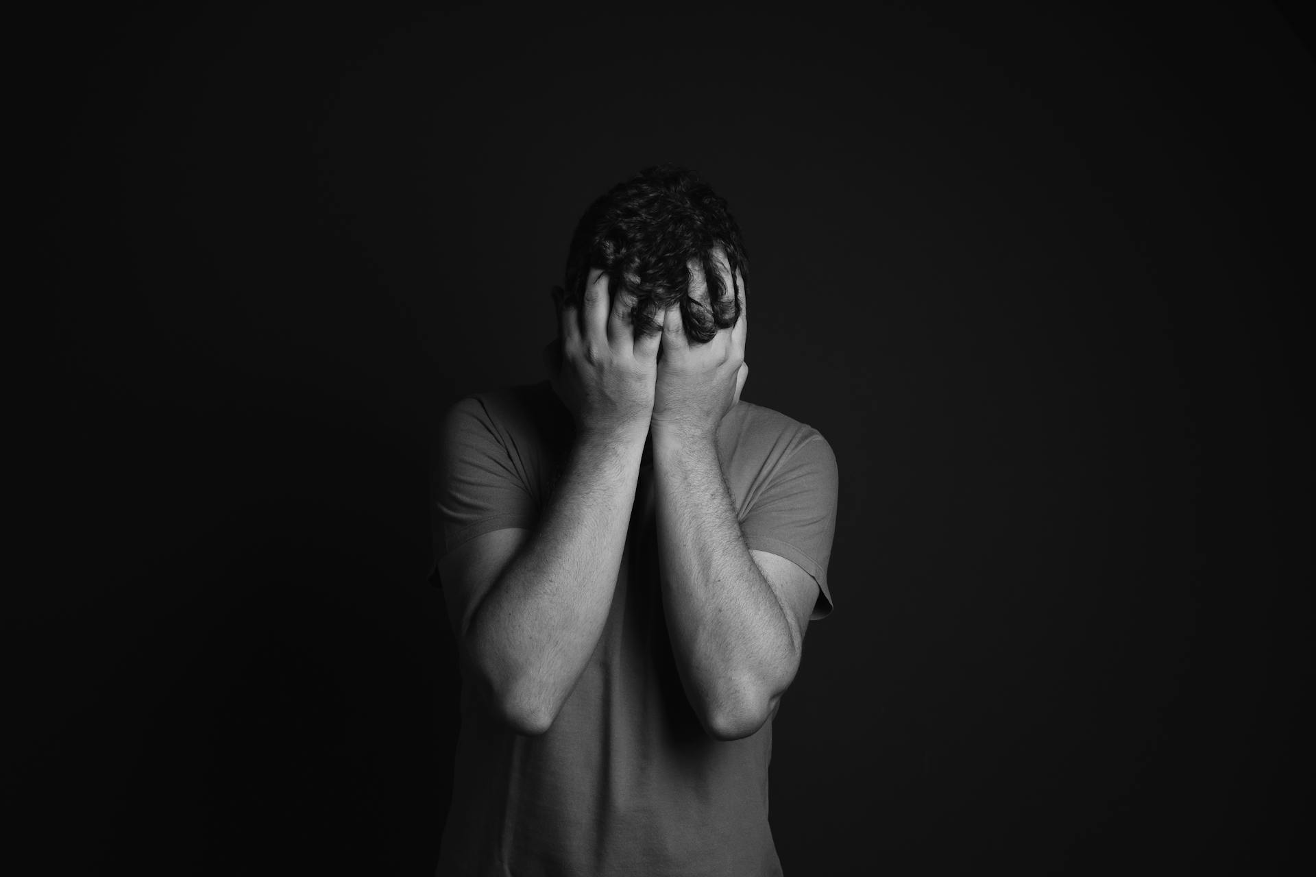 A distressed man holding his head | Source: Pexels