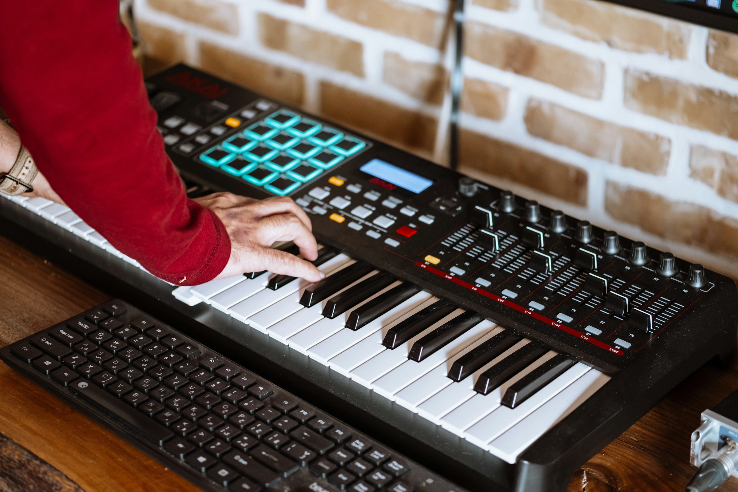 A man composing music on a synthesizer | Source: Unsplash